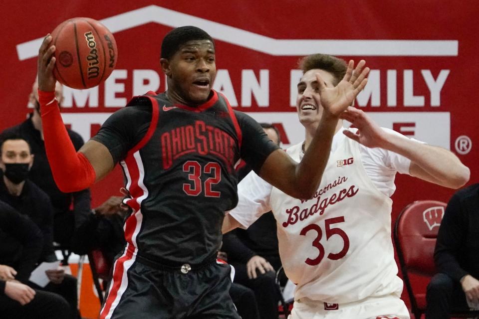 Ohio State's E.J. Liddell rebounds over Wisconsin's Nate Reuvers during their game in 2021.