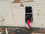 Cody Poole climbs out of a window in his family’s severely damaged home in Petal, Mississippi, after looking for clothing. Poole says that’s also how he and family members exited the home following a predawn tornado on Saturday, Jan., 21, 2017. Petal Mayor Hal Marx says more than 300 homes were damaged in his 10,000-resident city, along with hundreds more in its larger neighbor of Hattiesburg. The twister plowed a 25-mile path across south Mississippi, killing four people and injuring dozens. (AP Photo/Jeff Amy)