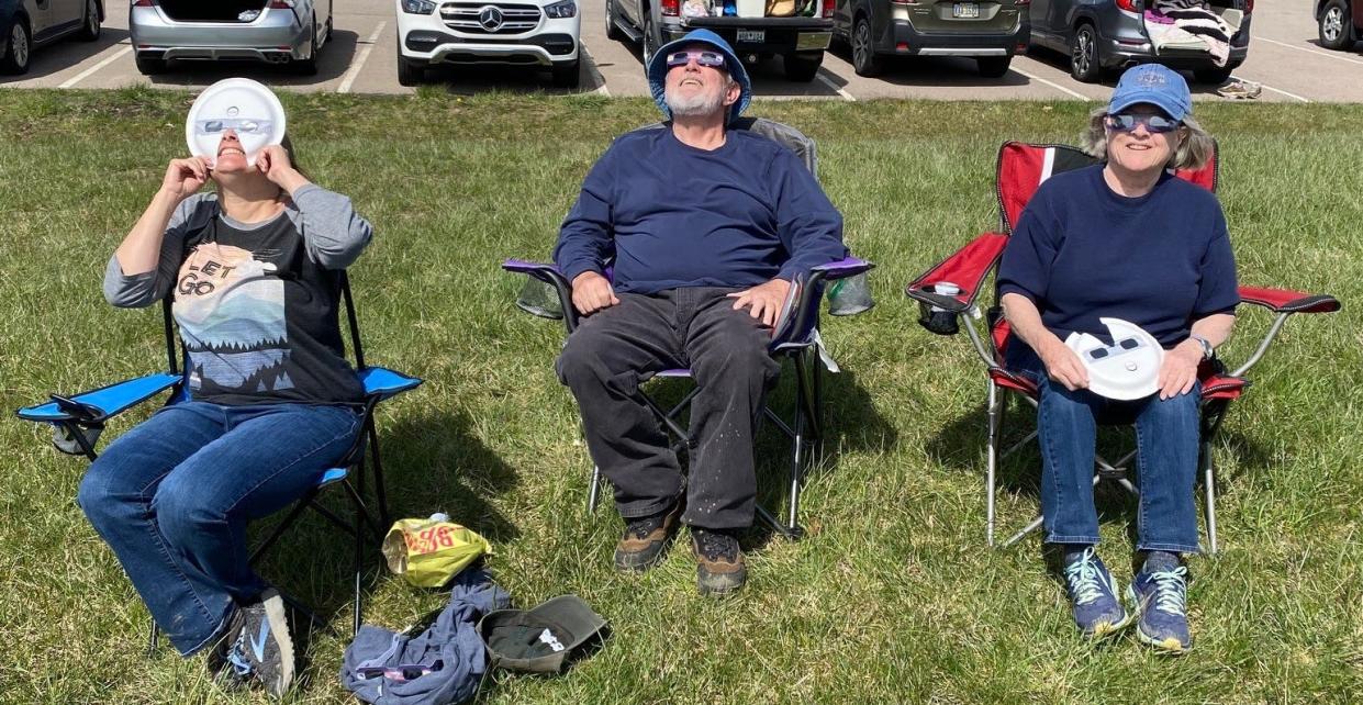 The campus of The Ohio State University Marion/Marion Technical College was a popular place to view the eclipse April 8. Among the visitors were Katie Rask, left, her uncle Steve O’Hair of South Carolina, and her mother, Terry Blackshear, of Columbus. (PROVIDED BY KATIE RASK)