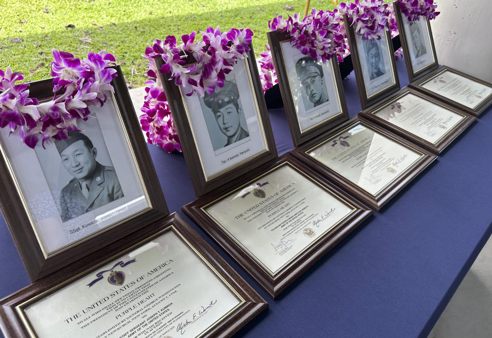 Photos of Hawaii men posthumously awarded Purple Heart medals sit on a table at Pearl Harbor, Hawaii, on Friday, May 10, 2024. The families of five Hawaii men who served in a unit of Japanese-language linguists during World War II received posthumous Purple Heart medals on behalf of their loved ones on Friday, nearly eight decades after the soldiers died in a plane crash in the final days of the conflict. (AP Photo/Audrey McAvoy)