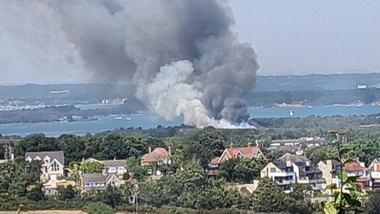 Handout photo taken with permission from the Twitter feed of @JD_GardenM of heavy black smoke rising from the scene on Studland Heath, Dorset, as a drought has been declared for parts of England following the driest summer for 50 years. Picture date: Friday August 12, 2022.