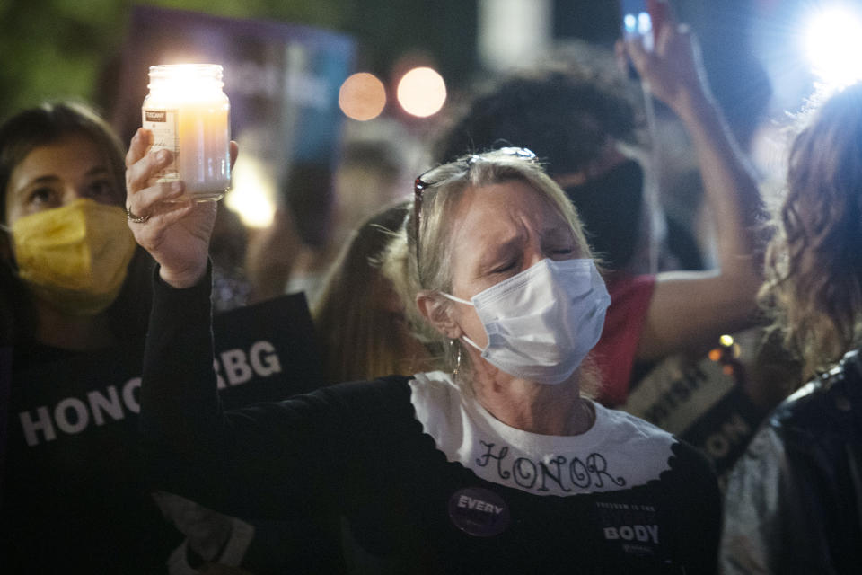 Gwendolyn Howard, of Fairfax, Va., takes part in a vigil, at the Supreme Court, to honor the late Justice Ruth Bader Ginsburg, Saturday, Sept. 19, 2020 in Washington. (AP Photo/Cliff Owen)