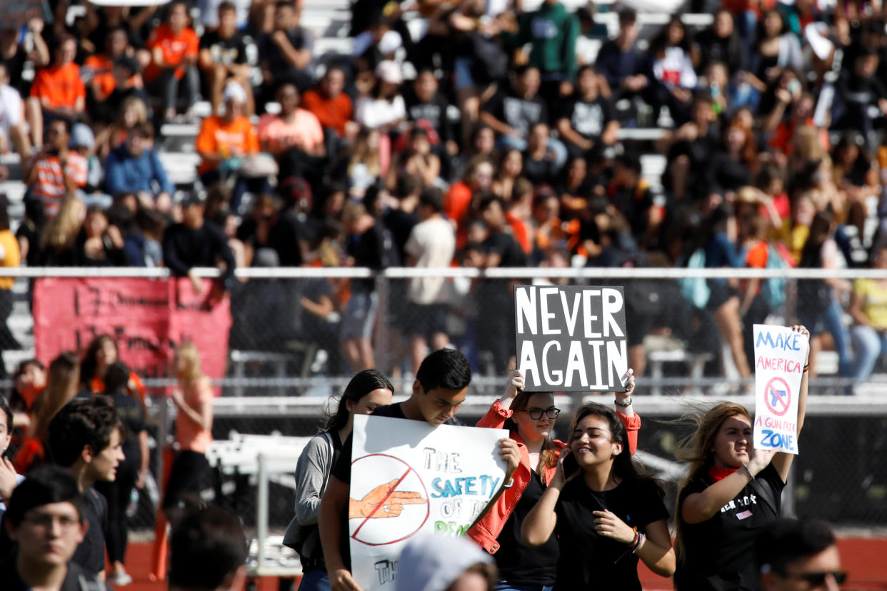 Students from Western High School in Davie, Florida, carrying placards, take part in a Feb. 21 protest in support of gun control following a mass shooting at nearby Marjory Stoneman Douglas High School. (Photo: Carlos Garcia Rawlins / Reuters)