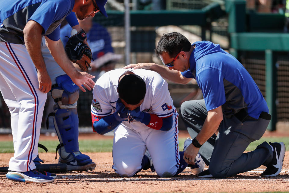 SURPRISE, AZ - MARCH 08: Texas Rangers left fielder Willie Calhoun (5) grabs his face after he's hit by a pitch during the spring training MLB baseball game between the Los Angeles Dodgers and the Texas Rangers on March 8, 2020 at Surprise Stadium in Surprise, Arizona. (Photo by Kevin Abele/Icon Sportswire via Getty Images)