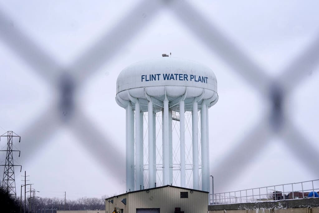 The Flint water plant tower is seen on Jan. 6, 2022, in Flint, Mich. A Michigan judge dismissed charges Tuesday, Oct. 4, 2022, against seven people in the Flint water scandal, including two former state health officials blamed for deaths from Legionnaires’ disease. (AP Photo/Carlos Osorio, File)