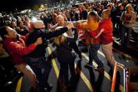 A crowd gathers as security guards break up a fight between shoppers waiting in line just as the doors open for Black Friday shopping at Target, Thursday, Nov. 22, 2012, in Bowling Green, Ky. Despite a surge of resistance as the sales drew near, with scolding editorials and protests by retail employees and reminders of frantic tramplings past, Black Friday's grip on America may be stronger than ever. (AP Photo/Daily News, Alex Slitz)