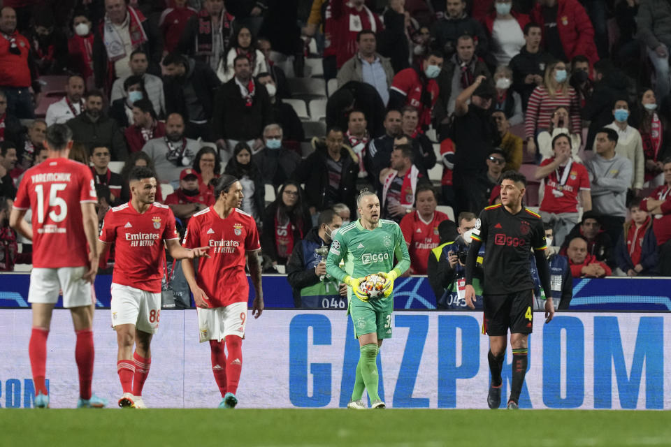 Advertisement of the Russian state-owned gas company Gazprom displayed on an advertising board as players gesture during the Champions League round of 16, first leg, soccer match between Benfica and Ajax at the Luz stadium in Lisbon, Wednesday, Feb. 23, 2022. (AP Photo/Armando Franca)