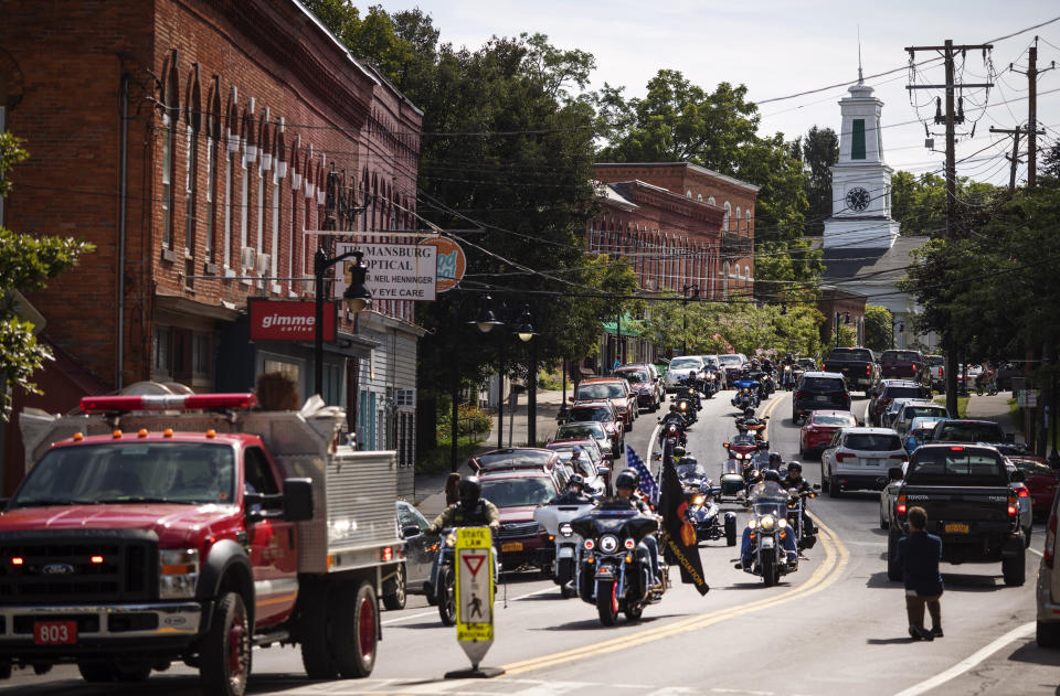 A memorial procession for Sgt. James Johnston, who was killed in Afghanistan in June, passes through Trumansburg, N.Y., Saturday, Aug. 31, 2019. Two months after his death, his adopted hometown had come together over a holiday weekend to pay tribute, and to say goodbye. (AP Photo/David Goldman)