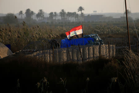 An Iraqi flag flies at a military camp near the border with Syria at al-Qaim, Iraq, November 25, 2018. REUTERS/Alaa al-Marjani