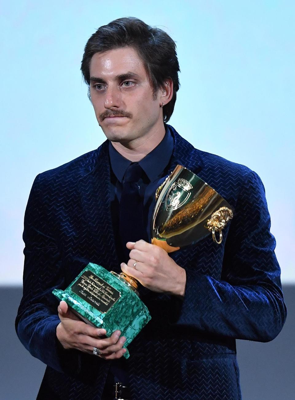 Italian actor Luca Marinelli holds the Volpi Cup award for the best male interpretation in the movie 'Martin Eden' of film director Pietro Marcello during the awarding ceremony of the 76th annual Venice International Film Festival in Venice, Italy, Saturday, Sept. 7, 2019. (Ettore Ferrari/ANSA via AP)