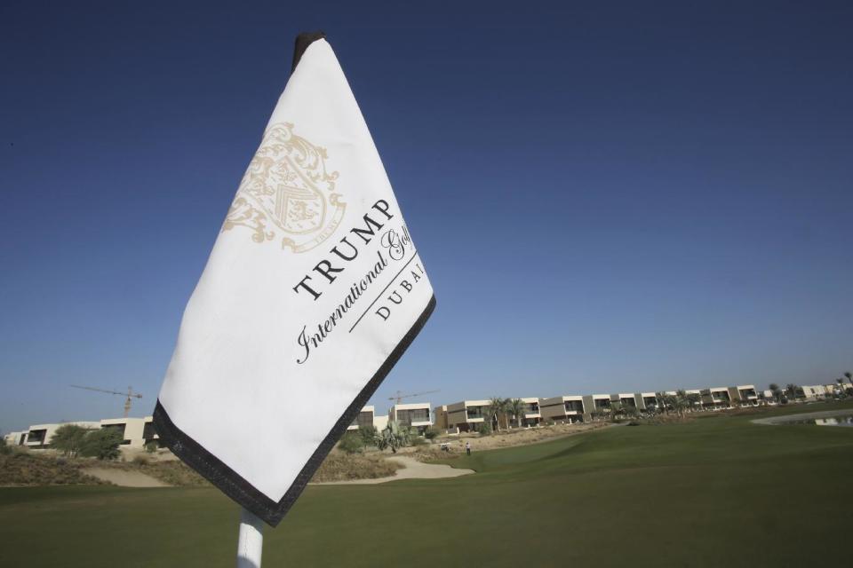 In this Tuesday, Dec. 20, 2016 photo, a flag flies on a green lined with villas at the Trump International Golf Club, in Dubai, United Arab Emirates. The 18-hole golf course in Dubai bearing Donald Trump’s name exemplifies the questions surrounding his international business interests. The course will open in February 2017 in the United Arab Emirates, but concerns about security, financial agreements and other matters have yet to be answered by the incoming 45th American president. (AP Photo/Kamran Jebreili)