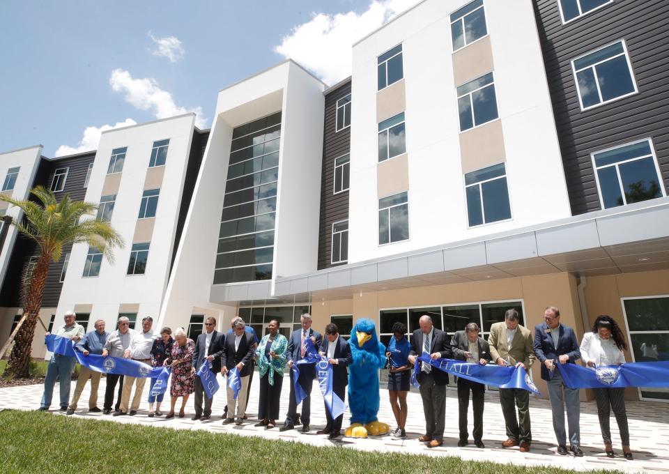 Staff celebrates the ribbon-cutting and dedication of the new student residence hall at Daytona State College, Thursday, May 5, 2022.