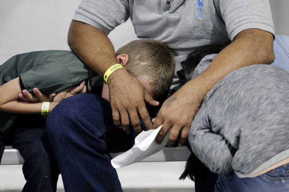 Migrants who are applying for asylum in the United States wait in a holding area at a new tent courtroom at the Migration Protection Protocols Immigration Hearing Facility, Tuesday, Sept. 17, 2019, in Laredo, Texas. (AP Photo/Eric Gay)