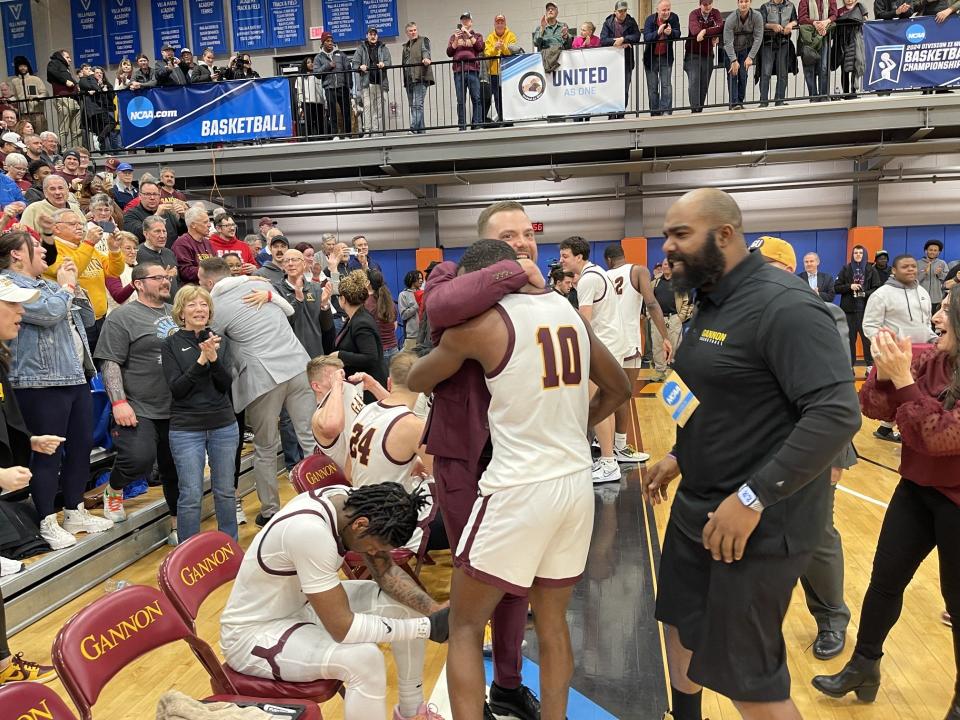 Gannon men's basketball celebrates winning the Atlantic Region title.