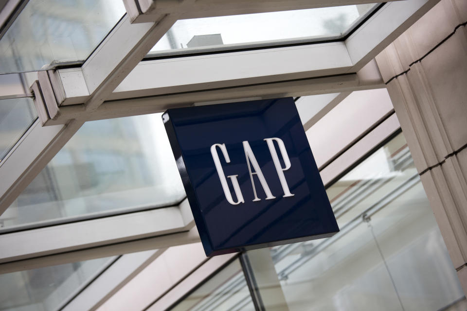 "Seattle, Washington, USA - May 27, 2012:  The logo and word mark of Gap, mounted above the entrance to the store in downtown Seattle."