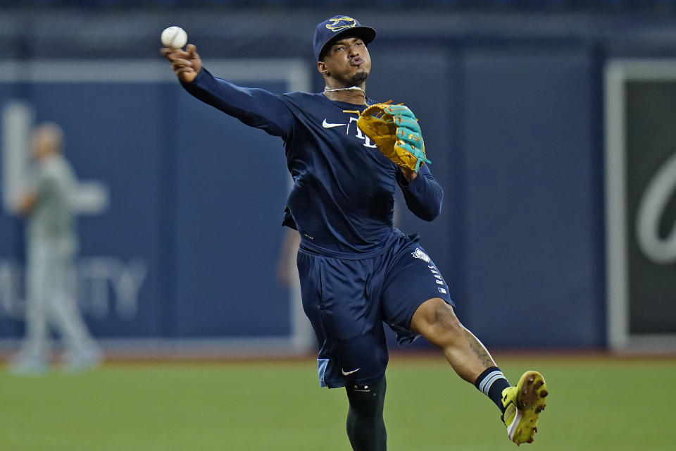 Tampa Bay Rays shortstop Wander Franco throws the ball during infield drills before a baseball game against the Toronto Blue Jays Monday, Sept. 20, 2021, in St. Petersburg, Fla. Franco expects to rejoin the team next week after injuring his hamstring. (AP Photo/Chris O'Meara)