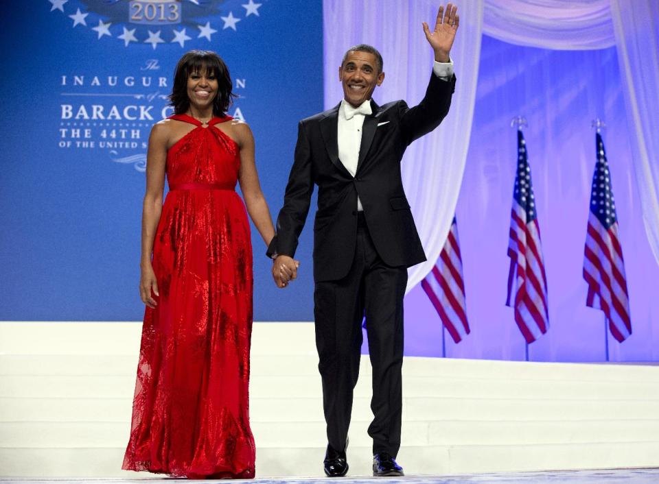 FILE - This Jan. 21, 2013 file photo shows President Barack Obama and first lady Michelle Obama at an Inaugural Ball at the Washington Convention Center in Washington, during the 57th Presidential Inauguration. Nobody would call bangs a new trend, but when the first lady's involved, things take on more significance. In fact, President Barack Obama did call his wife Michelle's new hairdo the most significant event of his second inauguration. (AP Photo/Carolyn Kaster, File)