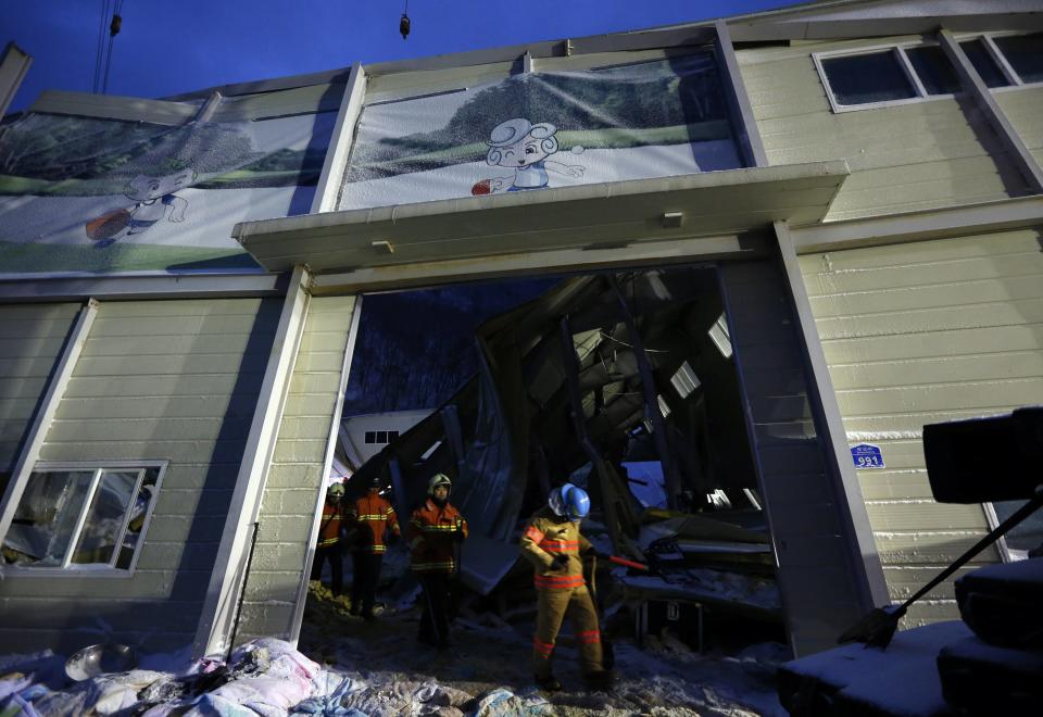 Rescue workers walk out of a collapsed resort building in Gyeongju