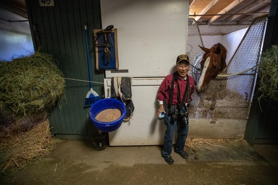 Bacon Sakatani tours a stable while on a tour of Santa Anita Park