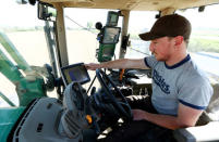 An employee of the "Poschinger Bray'sche Gueterverwaltung" company controls a tractor equipped with an iTC receiver (used for parallel driving) at a field in Irlbach near Deggendorf, Germany, April 21, 2016. REUTERS/Michaela Rehle