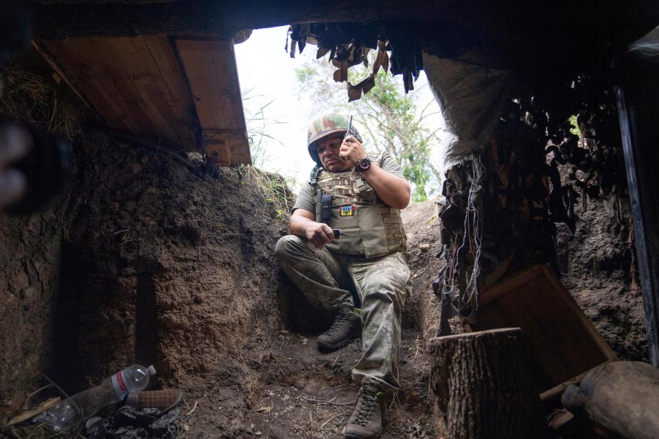 A Ukrainian serviceman speaks by radio at the frontline in the Kharkiv region on Wednesday.