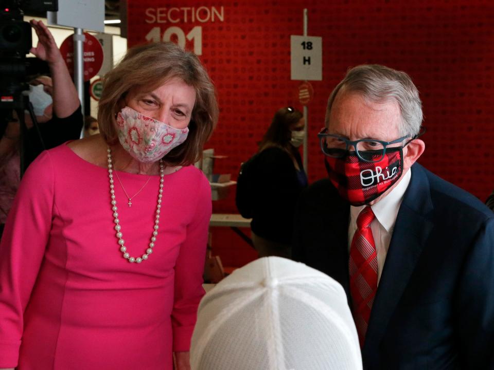 Ohio Governor Mike DeWine and First Lady Fran DeWine talk to a student while visiting the Columbus COVID-19 mass vaccination site at the Ohio State University's Schottenstein Center on Monday, April 5, 2021.