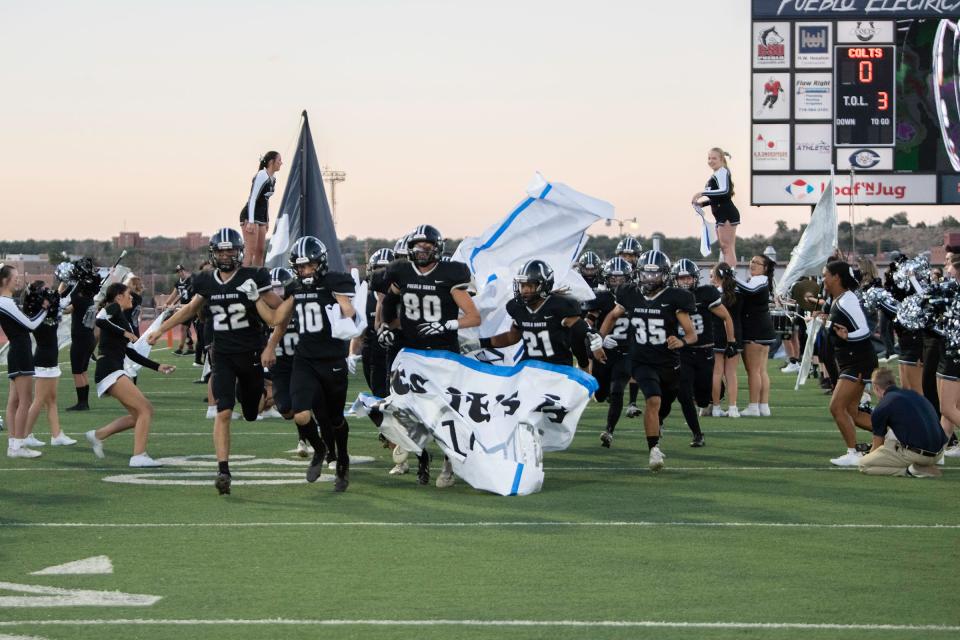 The Pueblo South High School football team take the field at Dutch Clark Stadium at the start of the 47th annual Cannon Game on Friday, Sept. 23, 2022.