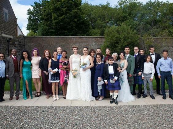 The couple (7th and 8th from right) at a family wedding (Navid Saberi)