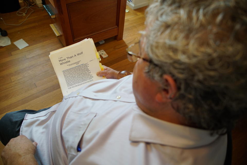 Author Timothy Tyson looks at a copy of Carolyn Bryant Donham's memoir in his home in Durham, N.C., on Thursday, July 14, 2022. (AP Photo/Allen G. Breed)