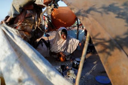 Zeinab's mother Abdir Hussein, 45, prepares tea for her family at a camp for internally displaced people from drought hit areas in Dollow, Somalia April 4, 2017. The family call this tent their kitchen. REUTERS/Zohra Bensemra