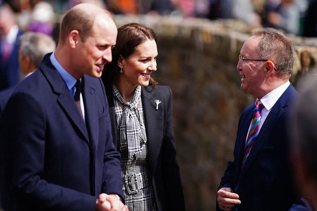 BEN BIRCHALL/POOL/AFP via Getty Images Prince William and Kate Middleton David Davies (R) during a visit to the Aberfan memorial garden