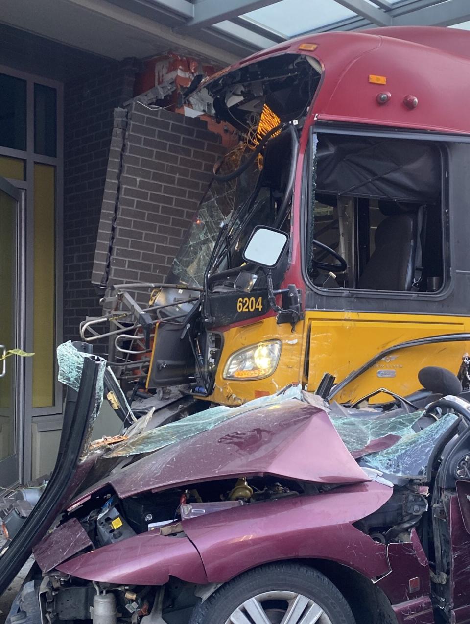 A metro bus in Seattle crashed into a building on Saturday in a crash with another vehicle that left one person dead and 12 others injured, according to police.