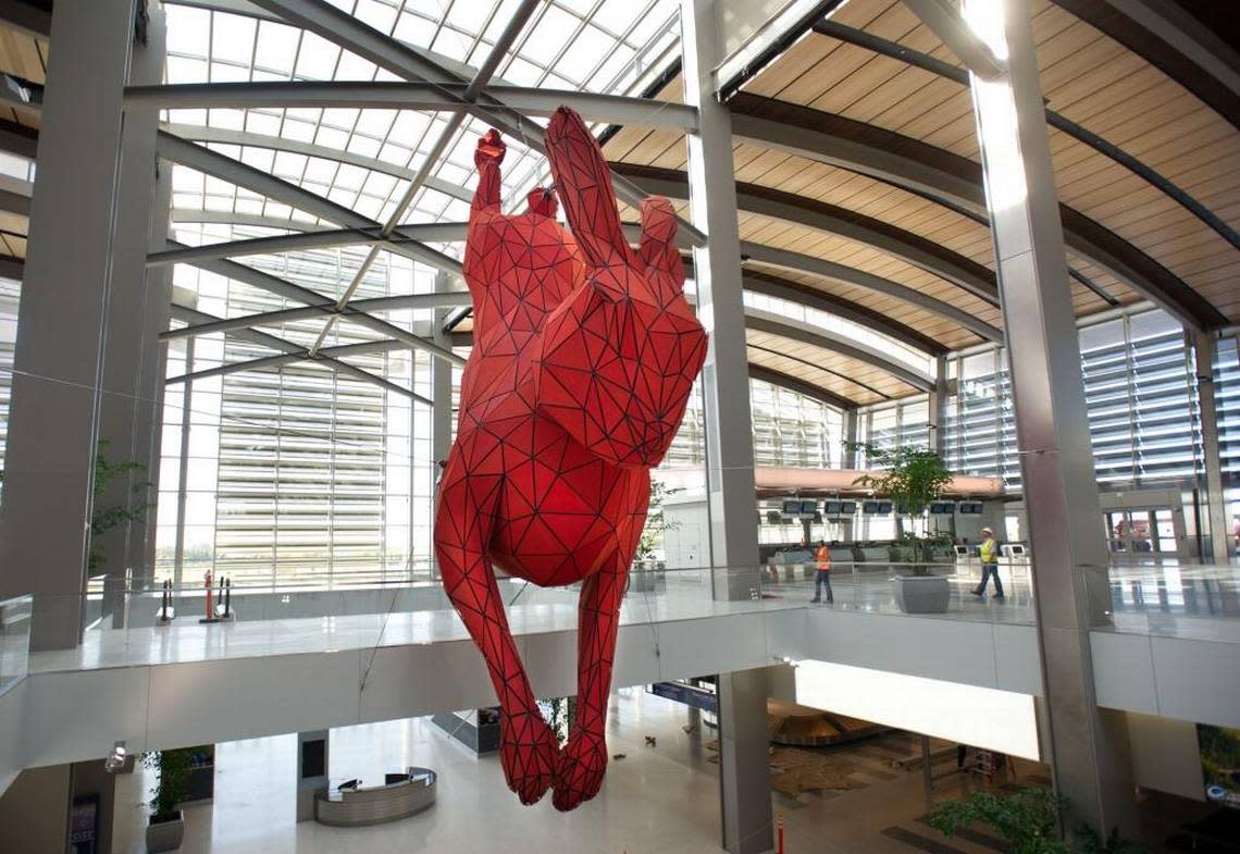 “Leap,” the 56-foot-long red rabbit seen inside Sacramento international Airport’s Terminal B, was created by Denver artist Lawrence Argent.