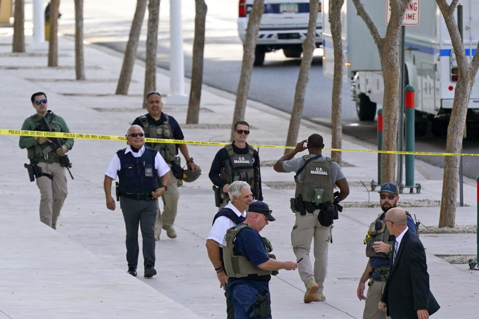 Federal law enforcement personnel patrol outside the Sandra Day O'Connor Federal Courthouse Tuesday, Sept. 15, 2020, in Phoenix. A drive-by shooting wounded a federal court security officer Tuesday outside the courthouse in downtown Phoenix, authorities said. The officer was taken to a hospital and is expected to recover, according to city police and the FBI, which is investigating. (AP Photo/Ross D. Franklin)