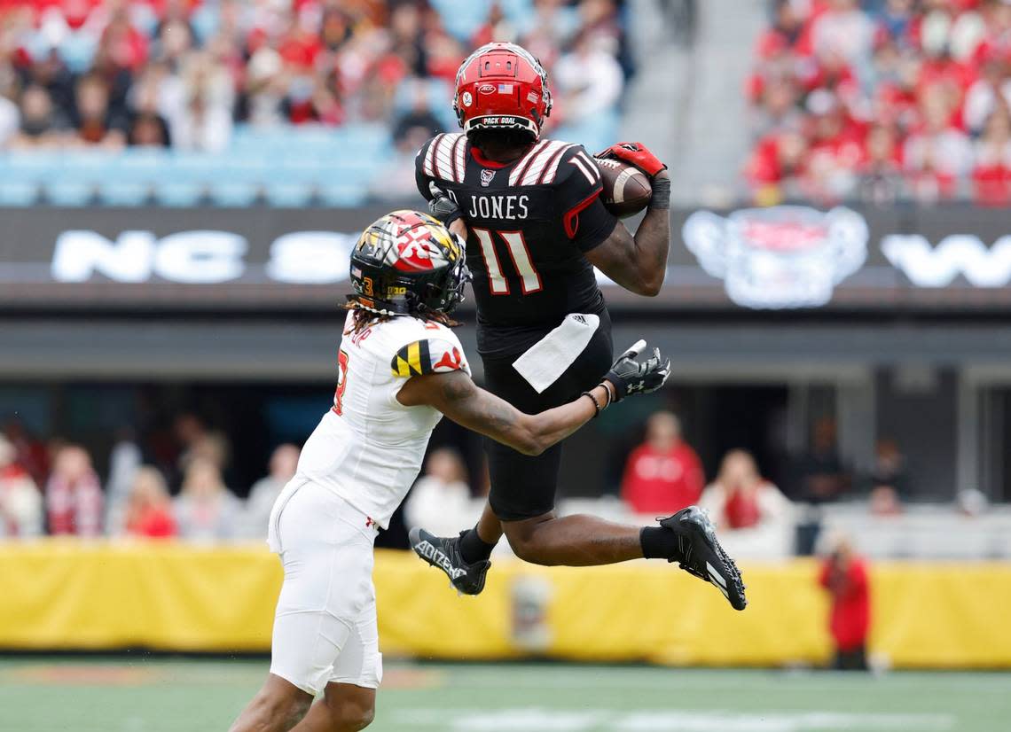 N.C. State wide receiver Darryl Jones (11) pulls in the reception as Maryland defensive back Deonte Banks (3) defends during the first half of N.C. State’s game against Maryland in the Duke’s Mayo Bowl at Bank of America Stadium in Charlotte, N.C., Friday, Dec. 30, 2022.