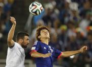 Greece's Giannis Maniatis fights for the ball with Japan's Yuya Osako (R) during their 2014 World Cup Group C soccer match at the Dunas arena in Natal June 19, 2014. REUTERS/Sergio Moraes