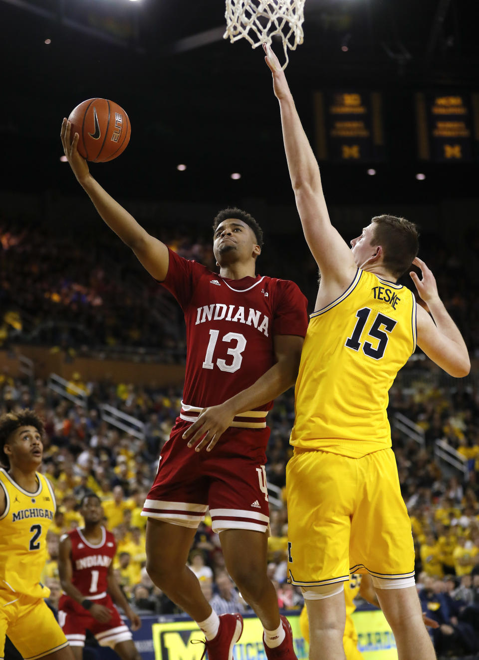 Indiana forward Juwan Morgan (13) shoots on Michigan center Jon Teske (15) in the first half of an NCAA college basketball game in Ann Arbor, Mich., Sunday, Jan. 6, 2019. (AP Photo/Paul Sancya)