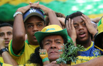 <p>Fans react during the match as they watch the broadcast. REUTERS/Sergio Moraes </p>