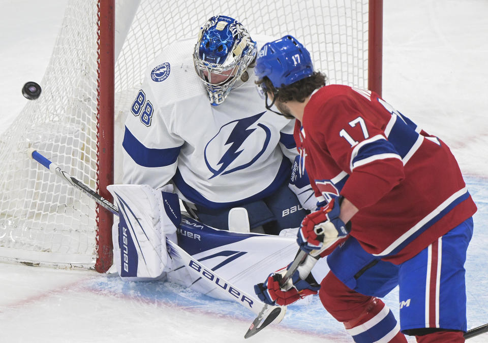 Montreal Canadiens' Josh Anderson (17) moves in on Tampa Bay Lightning goaltender Andrei Vasilevskiy during the first period of an NHL hockey game Tuesday, March 21, 2023, in Montreal. (Graham Hughes/The Canadian Press via AP)