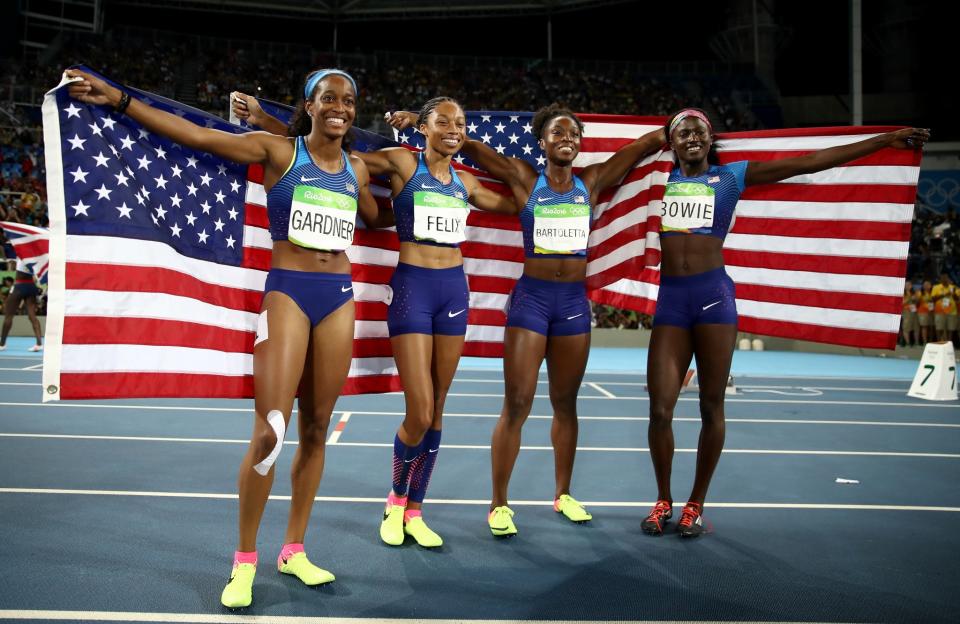 <p>English Gardner, Allyson Felix, Tianna Bartoletta and Tori Bowie of the United States celebrate winning gold in the Women’s 4 x 100m Relay Final on Day 14 of the Rio 2016 Olympic Games at the Olympic Stadium on August 19, 2016 in Rio de Janeiro, Brazil. (Photo by Cameron Spencer/Getty Images) </p>
