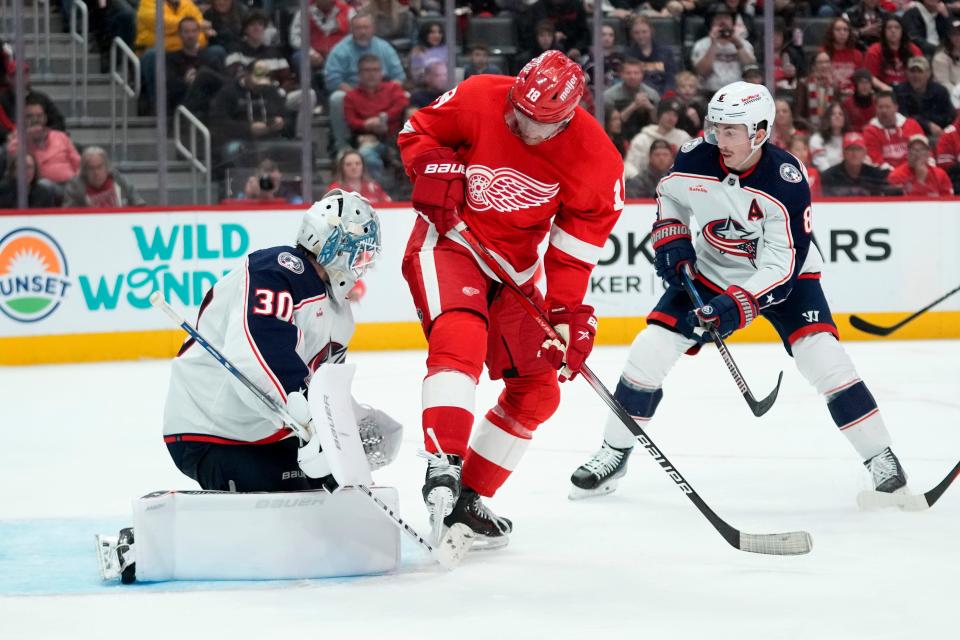 Columbus Blue Jackets goaltender Spencer Martin (30) stops a shot as Detroit Red Wings center Andrew Copp (18) screens while Zach Werenski (8) defends in the second period of an NHL hockey game Saturday, Nov. 11, 2023, in Detroit. (AP Photo/Paul Sancya)