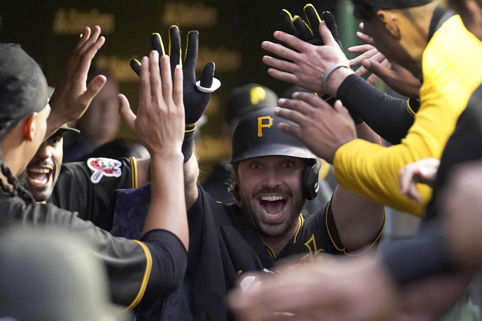 Pittsburgh Pirates' Austin Hedges is congratulated in the dugout after his home run off Chicago Cubs starting pitcher Drew Smyly during the fourth inning of a baseball game Wednesday, June 14, 2023, in Chicago. (AP Photo/Charles Rex Arbogast)