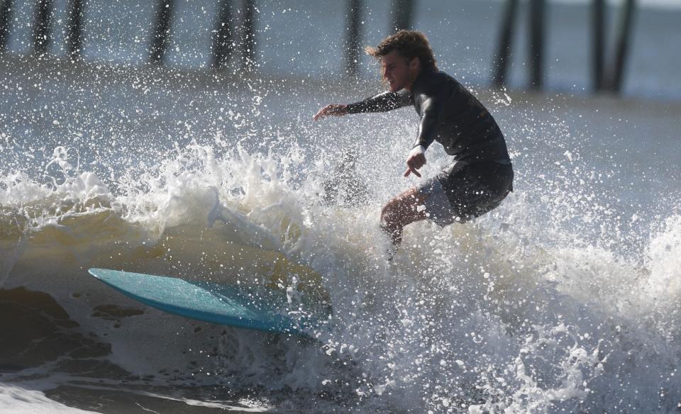Gianni Pike catches a wave next to the Surf City Ocean Pier in Surf City, N.C., Wednesday, Sept. 30, 2020.