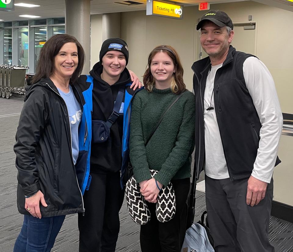 Adeline Albert, second from left, poses for a photo with mother Renee, fraternal twin Avah and father Rob after returning to Columbus on Friday. Adeline, a sophomore at Thomas Worthington, suffered a traumatic brain injury Feb. 7 during a luge training accident in South Korea.