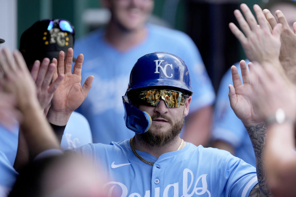 Kansas City Royals' Kyle Isbel celebrates in the dugout after scoring on a ground out hit into by Maikel Garcia during the sixth inning of a baseball game against the Oakland Athletics Sunday, May 19, 2024, in Kansas City, Mo. (AP Photo/Charlie Riedel)