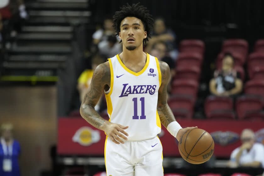 Los Angeles Lakers'  Jalen Hood-Schifino drives up the court against the Golden State Warriors during the second half of an NBA summer league basketball game Friday, July 7, 2023, in Las Vegas.  (AP Photo/John Locher)