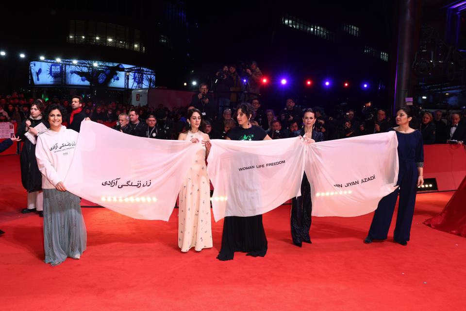 Activists including Zahra Amir Ebrahimi, Melika Foroutan and Jasmin Tabatabai show a banner with the slogan “Women Life Freedom” on Thursday