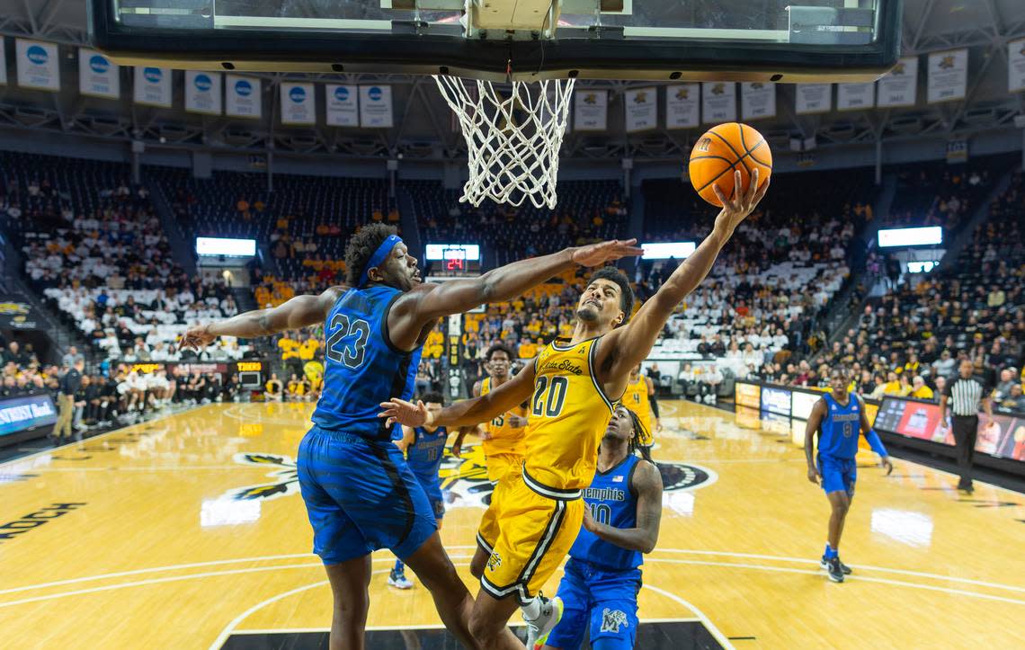 Wichita State’s Harlond Beverly tries to make a shot against Memphis defender Malcolm Dandridge, left, during the first half on Sunday at Koch Arena 