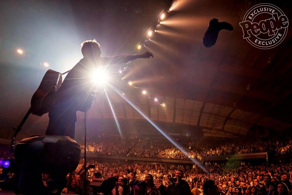 Church tosses a boot back to its lucky owner after adding his autograph during the singing of "These Boots." Before the song was done, Church had his hands full with a bevy of boots that he had signed for his Chicago fans.