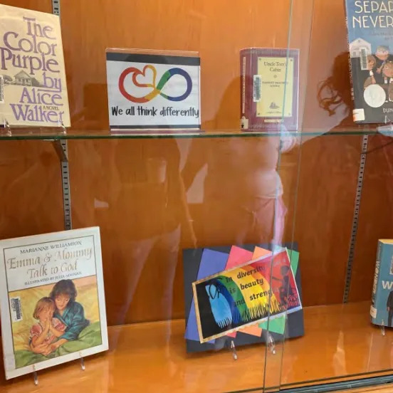 This photo from a federal lawsuit shows a display in the Sterling Free Public Library. The multicolored infinity symbol represented autism awareness. The other colorful image has a child in a wheelchair and a Maya Angelou quote. Library board officials believed the rainbows promoted an "LGBTQ agenda" during Pride Month.